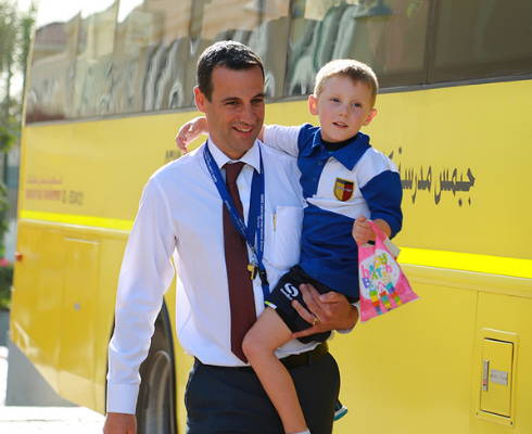 Parent and child next to bus