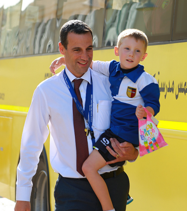 Parent and child next to bus